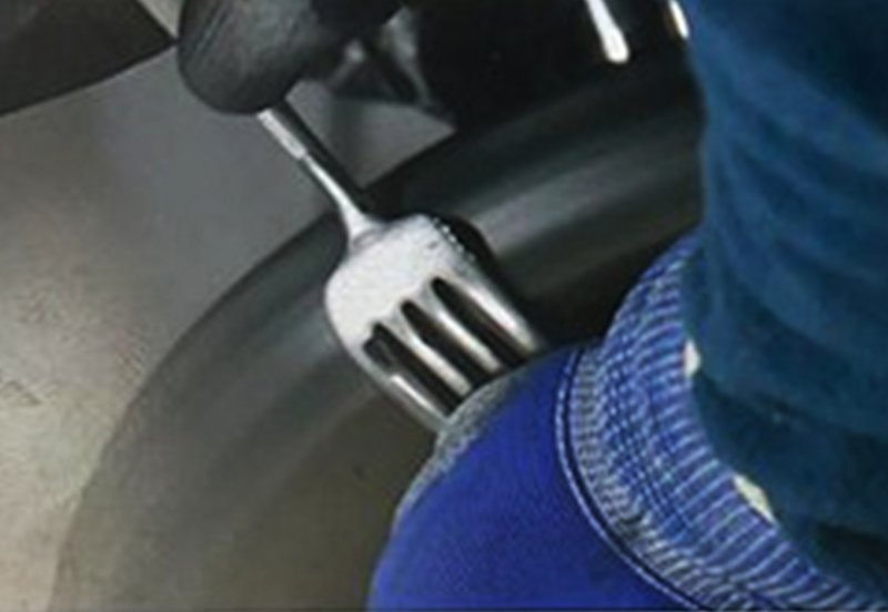 Close-up of stainless steel fork during the polishing process