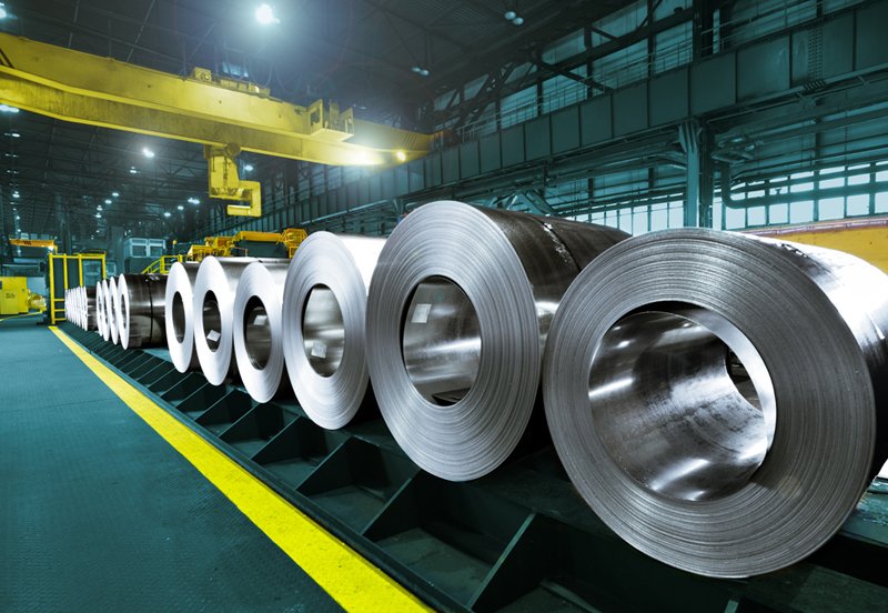 Stainless steel coils stored on the Agam Industries factory floor
